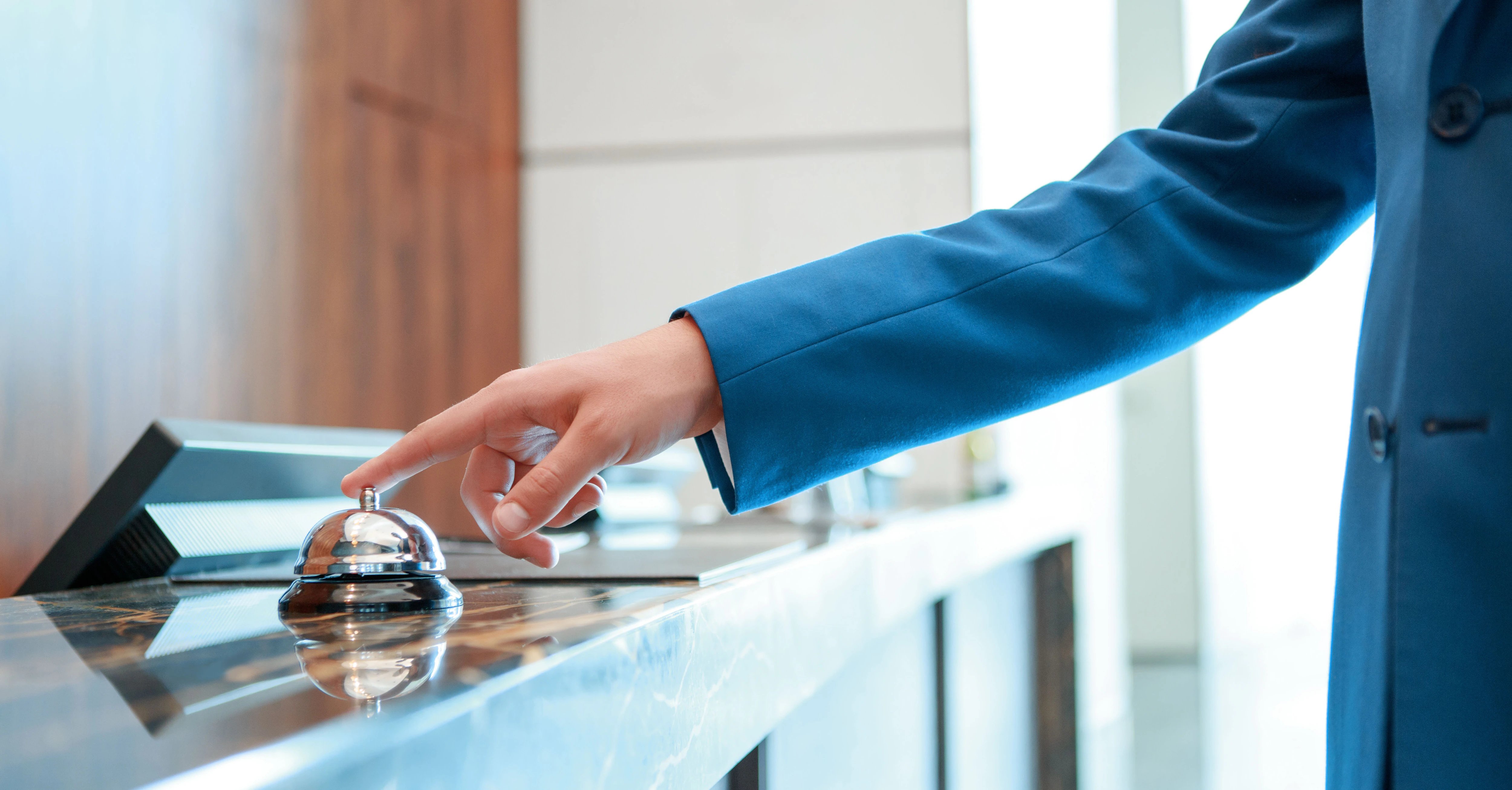 Man-Checking-in-to-Hotel-Front-Desk1
